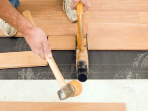 worker installing new cumuru hardwood floor 186852280 5827f3bc5f9b58d5b11372fc